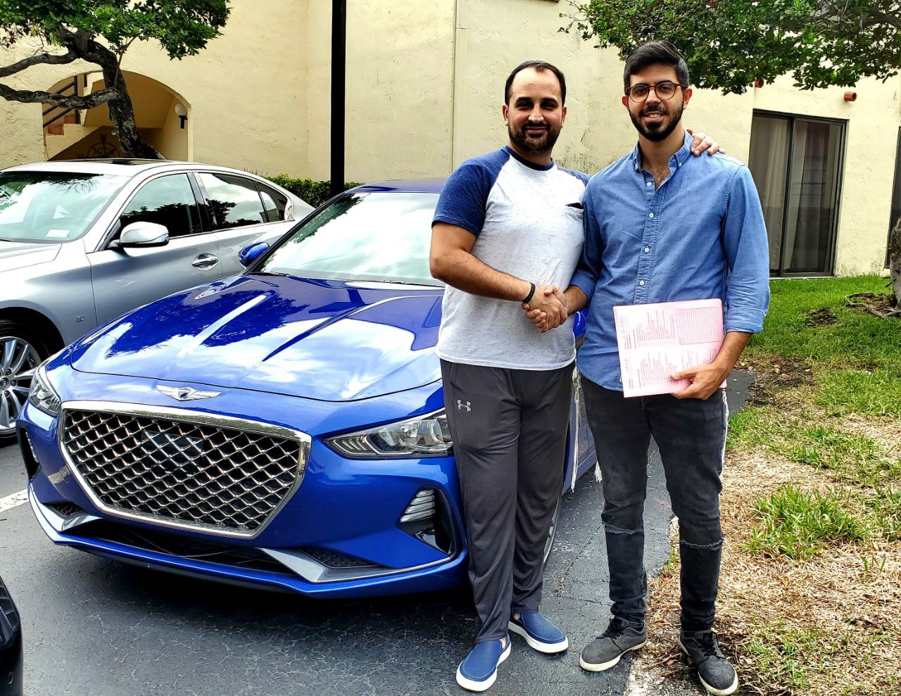 Adam delivering a Genesis G70 to a customer
